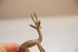 Close-up of the vintage gazelle's head, showing its slender antlers and golden patina.