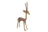 Stylized vintage African gazelle sculpture with a slender form and warm patina.