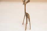 Rear view of the vintage African gazelle showing its slender legs and handmade texture.
