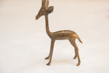 Vintage African gazelle sculpture showing its slender, handmade form and aged patina.