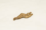 Rustic spotted texture along the curved side of the African snake pendant.