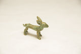Profile view of the vintage bronze hare sculpture highlighting its aged green patina.