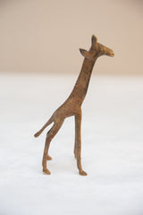 Handmade vintage African bronze giraffe with speckled texture detail on its back.