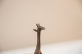 Close-up of the vintage bronze giraffe's head, highlighting its speckled, aged texture.