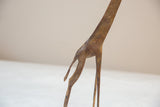 Textured hind legs and tail of a vintage African bronze giraffe sculpture.