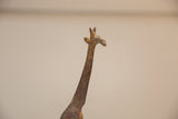 Vintage African bronze giraffe head and neck, showing etched patterns and light patina.