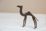 Stylized profile of a vintage African dark bronze camel showing its handmade texture.