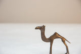 Side profile detail of the vintage bronze camel's head and long, curved neck.