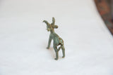 Rear view of the vintage African bronze ram showing its aged, handmade patina.