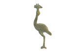 Vintage African flat stork sculpture with a weathered, oxidized green finish holding a fish.