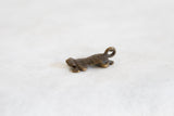 African dark bronze turtle hatchling pendant with textured shell and aged patina.