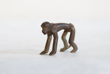 Handmade African dark bronze monkey sculpture, displaying its textured patina.