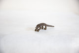 Angled view of a vintage dark bronze pangolin, highlighting its handmade scaly texture.