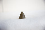 A small vintage African bronze bell with a simple form and dark, smooth finish.