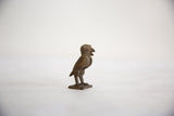Vintage African bronze owl sculpture, handmade with deep patina and textured surface, in profile.