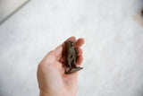 Hand-held vintage African bronze owl, showing its unique texture and aged patina.