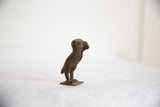 Vintage African bronze owl sculpture, showing its textured side profile and aged patina.