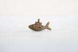 Angled side view of the bronze African fish pendant showing its textured wire design.