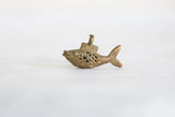 Full side silhouette of a handmade bronze fish pendant with an open mesh body.