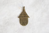 Handmade African bronze hut pendant with incised roof and dotted body details.