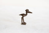 The handmade texture and profile of a vintage African crowned stork in dark bronze.