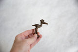 Vintage African bronze crowned stork held in hand to demonstrate its scale.