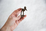 Vintage African bronze crowned stork held in hand to show its small scale.