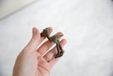 Vintage African bronze stork held in hand showing its collectible size and texture.