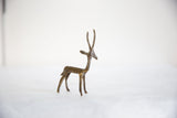 Vintage dark bronze gazelle figurine with its head elegantly turned back.