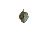 Vintage African oxidized bronze mask pendant with stylized facial features.