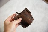 Handmade African iron cow bell with rugged texture and deep rust patina.