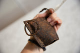 Heavily textured iron surface and aged bottom edge of the vintage African cow bell.