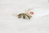 Handmade vintage bronze pangolin pendant showing its scaly texture and oxidized patina.