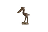 Vintage handmade African bronze stork figurine with a fish, showing a dark aged patina.
