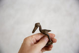 Vintage dark bronze stork sculpture showing its scale and handmade textural details.