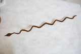 Sinuous vintage African iron snake sculpture with a rustic brown patina.