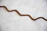 Rich patina and textured surface of the vintage African iron snake.