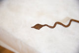Handmade iron snake head with weathered texture and rich, warm brown patina.
