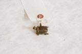 Vintage African bronze turtle pendant with mesh shell attached to its paper tag.