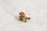 Oxidized bronze turtle pendant with intricate spiral wire design on its shell.