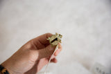 Hollow underside and textured finish of the vintage bronze turtle pendant.