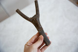 Vintage African wooden talisman showing hand-carved circular patterns on its base.