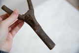 Aged dark wood of the vintage African talisman with hand-carved circular markings.