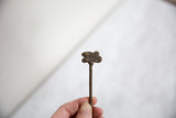A view of the vintage bronze pin's top showing its handmade texture and charm.