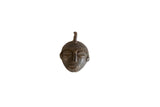 Vintage African mask pendant in dark bronze with hand-cast textured details.