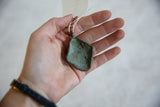 Hollowed reverse side of the vintage bronze pendant showing its oxidized green patina.