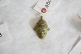 Handmade vintage African mask pendant with a unique oxidized green patina.