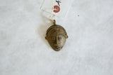 Vintage African bronze mask pendant with hand-etched details and an aged patina.