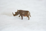 Profile view of a vintage bronze African rhino with a textured, aged patina.