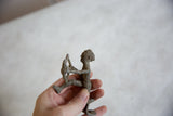 Textured head and torso of the handmade African aluminum archer figure.